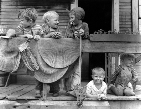 Children of miners on front porch of house in company project. Louise Coal Company, Louise Mine, Osage, Monongalia County, West Virginia, 1946  Silver gelatin print  Russell Lee 