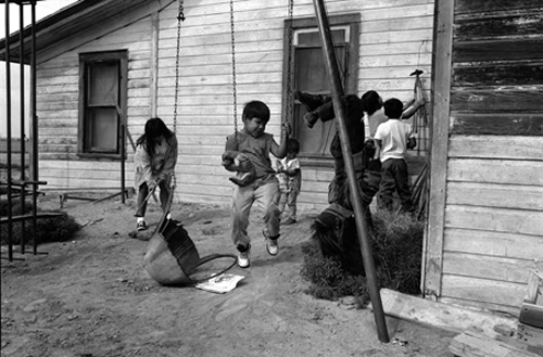 Children Playing Outside Migrant Worker's  Home, Worland, Wyoming, 1996, Silver gelatin print, Bill Wright 